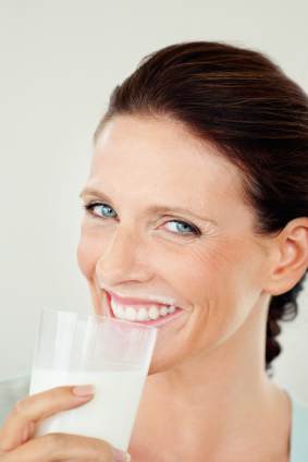 a woman drinking a glass of milk