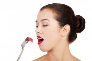 Woman Eating Meat